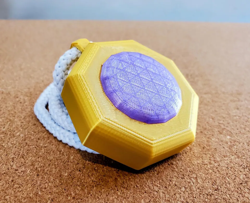 Side view of the glory amulet showing the layered gold frame